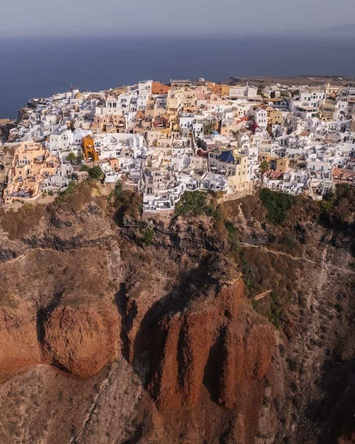 Breathtaking aerial view of Santorini's iconic cliffside architecture overlooking the Aegean Sea.