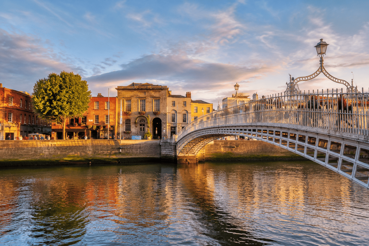 Ha Penny Bridge over the River Liffey in Dublin at golden hour