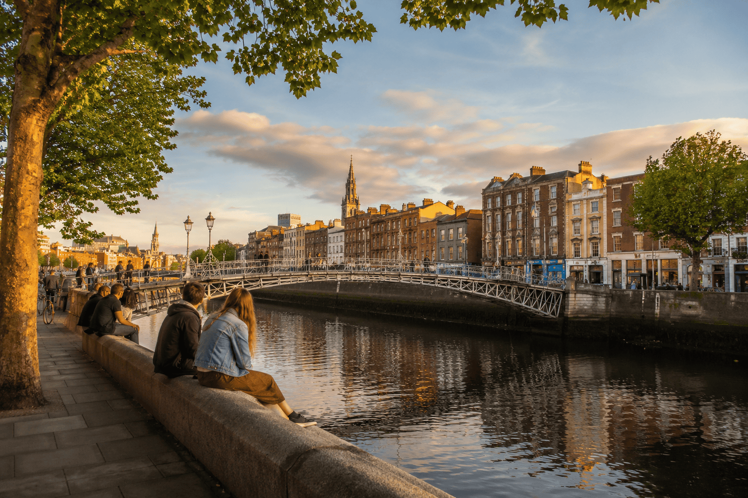 People walking near the River Liffey in Dublin during golden hour